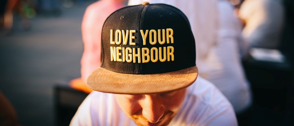 Photo of man wearing a cap saying Love your neighbour